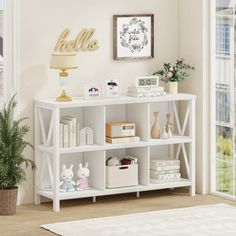 a white shelf filled with books and stuffed animals