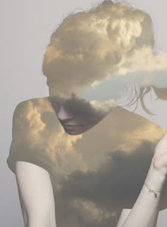 a woman holding up a piece of paper in front of her face with clouds above her head