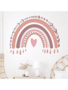 a wall decal with an image of a rainbow and hearts in the middle, on top of a bed