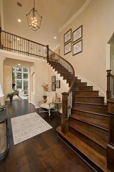 a staircase leading up to the second floor in a house with wood floors and white walls