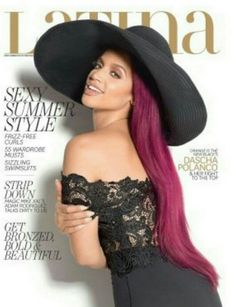 a woman with long pink hair wearing a black hat on the cover of a magazine