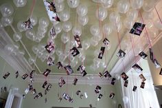 some balloons and pictures hanging from the ceiling