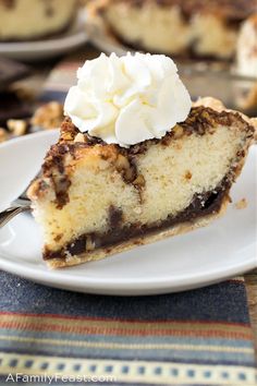 a slice of chocolate chip cheesecake on a white plate with a bite taken out