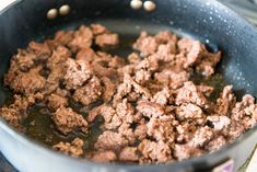 meat is cooking in a pan on the stove