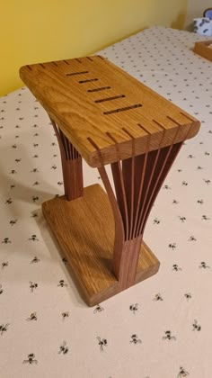 a wooden bench sitting on top of a bed