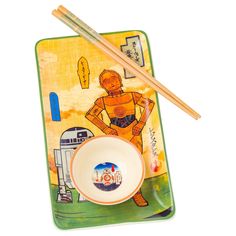 two chopsticks and a bowl on a plate with an image of a man