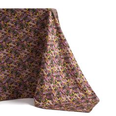 a purple and green floral print tablecloth on a white background with a black border