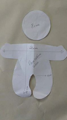 two pieces of paper cut out to look like a baby's diaper with measurements