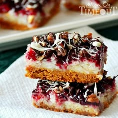 two pieces of dessert sitting on top of a white napkin