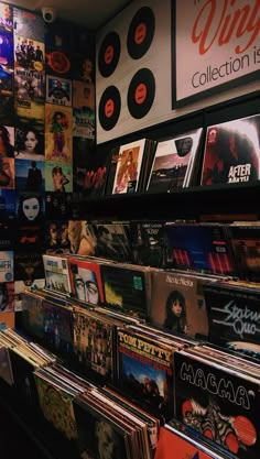 a record store with various records on the wall and posters on the wall behind it