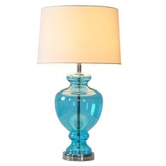 a blue glass table lamp with a white shade