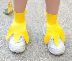 a person wearing yellow gloves and white shoes