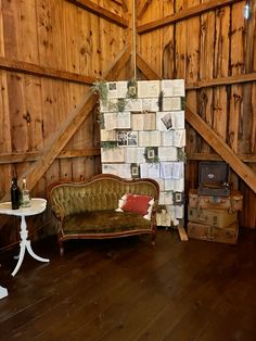 an old couch and table in a room with wood paneling on the walls, next to a brick fireplace