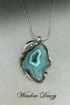 a necklace with a green agate stone in the center