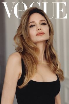 a woman in a black dress is featured on the cover of a magazine with long hair