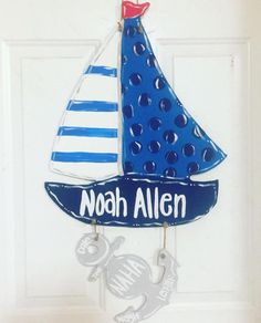 a door hanger with a sailboat and anchor on it that says noah allen