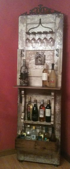 an old wooden shelf with wine bottles on it