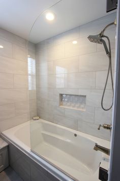 a bath tub sitting next to a toilet in a bathroom