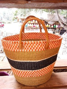 This is an African Sisal and Leather handbag or Planter Handmade in Kenya. It's made from Sisal Fibers and dyed in using natural dyes. It can be made with or without the leather handles depending on preference and use. Planters usually have the leather handles. It is used as a carry on handbag for your laptop, books or for clothes for an overnight stay.  Larger ones can be used for organizing your living room as storage for shawls or books. Larger ones can also be used as laundry baskets. They c Brown Bucket Beach Bag With Handles, Red Shoulder Bag With Leather Handles For Market, Red Woven Basket Beach Bag, Red Woven Beach Bag In Basket Shape, Red Woven Crochet Bag For Market, Red Handwoven Beach Bag For Market, Red Handwoven Beach Bag For Shopping, Red Handwoven Bucket Straw Bag, Red Woven Bucket Bag