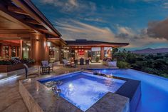 an outdoor hot tub in the middle of a patio