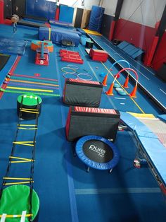 an indoor trampoline park with many obstacles