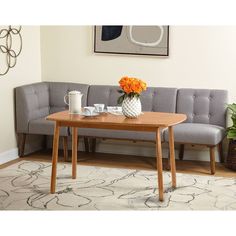 a living room with a couch, table and coffee cup on the floor in front of it