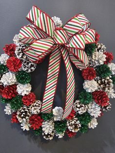 a christmas wreath with pine cones and candy canes