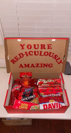 an open box with some candy in it on top of a white table and the words you're ridiculous amazing