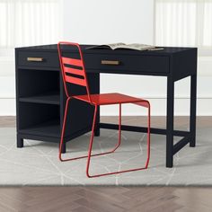 a black desk with a red chair next to it