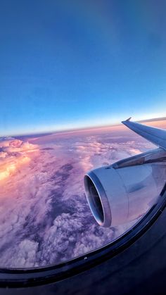 the wing of an airplane flying over clouds