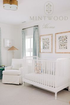 a baby's room with a white crib and blue curtains