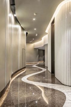 an elegant hallway with marble floors and walls