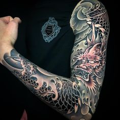 a man with a dragon tattoo on his arm