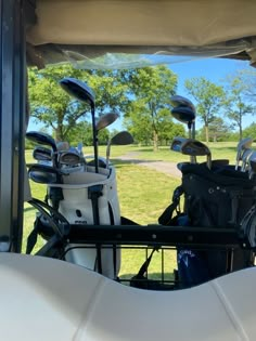 several golf clubs are sitting in the back of a vehicle