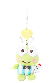 a green stuffed animal holding a heart shaped keychain with eyes and nose on it