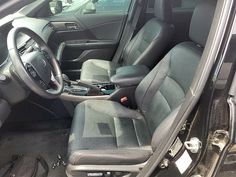 the interior of a car with grey leather seats