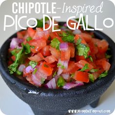 a black bowl filled with chopped vegetables on top of a white countertop next to a sign that says chipotle inspired pico de galloo