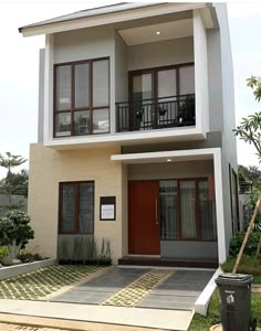 two story house with balconies on the second floor