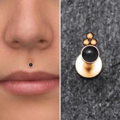 the nose is adorned with a black stone and gold plated earring, while the nose ring has a small diamond on it