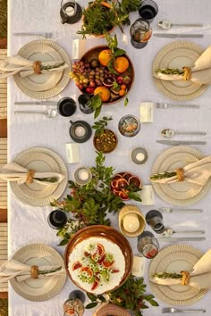 an overhead view of a table set with plates and silverware