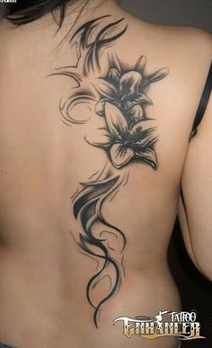 the back of a woman's body with flowers on it