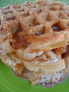 a stack of waffles sitting on top of a green plate