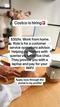 a person sitting at a desk with a laptop and coffee in front of them that says costo is hiring