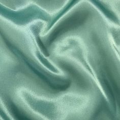 "Elevate your special occasion creations with Sedona Designz Premium Bridal Wedding Satin Charmeuse Fabric. Made from 100% polyester, this luxurious fabric boasts a lightweight feel that is both soft and smooth to the touch, making it the perfect choice for bridal gowns, bridesmaid dresses, and elegant evening wear. With a width of 60 inches, this fabric provides ample material for crafting exquisite garments that drape beautifully and exude sophistication. This high-quality satin charmeuse fabr Pastel Green Fabric, Christmas Showcase, Mint Green Wedding, Elegant Evening Wear, Wedding Mint Green, Bella Wedding, Delicate Lingerie, Charmeuse Fabric, Gowns Bridesmaid