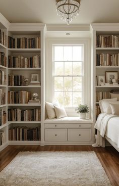 a bedroom with lots of bookshelves and a bed in front of the window