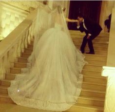 a bride and groom walking down the stairs