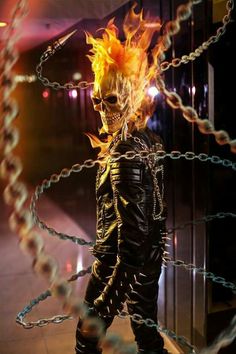 a man with fire on his head and chains around him