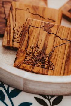 wooden coasters with the state of minnesota engraved on them