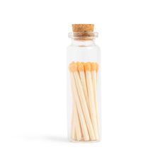 matches in a glass jar on a white background