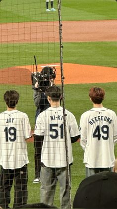 the baseball players are getting ready to take their turn on the field at home plate